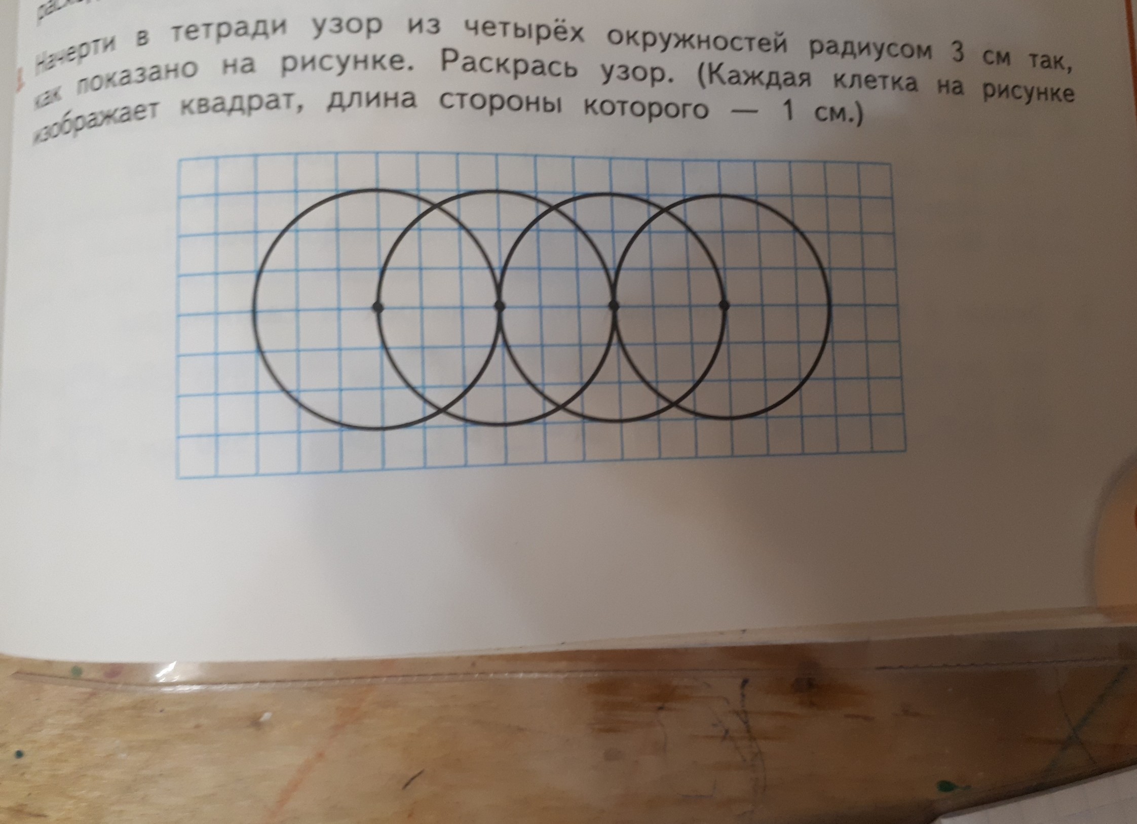 Начерти в тетради 3. Рисование окружностей узоры на клетках. Начерти в тетради такой узор. Узор из окружностей в тетради. Начерти в тетради узор из четырех окружностей радиусом 3см.